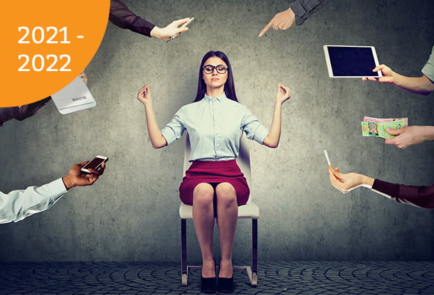 photo: business woman meditating, surrounded by stressors (iStockphoto)