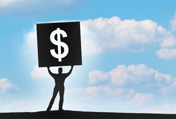 photo: figure holds large dollar sign to the sky (iStockphoto)
