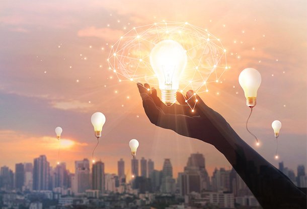 photo: city skyline with hand holding lightbulb (iStockphoto)