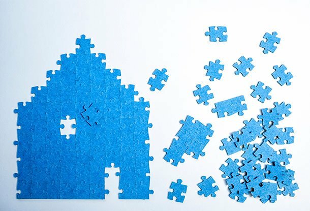 image: puzzle house with pieces falling into place (iStockphoto)