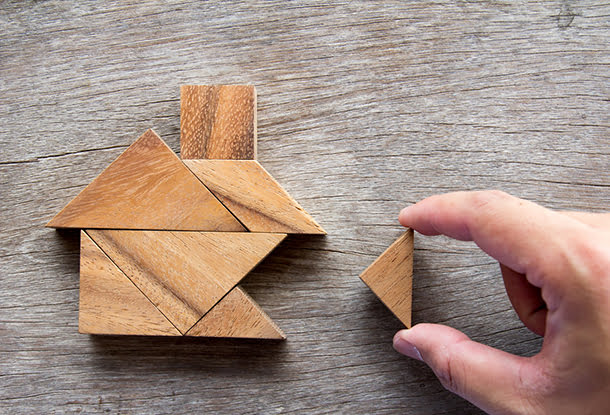 photo: hand completes tangram of a house (iStockphoto)