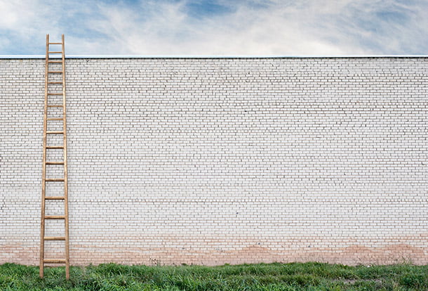 Ladder over a wall (iStockphoto)