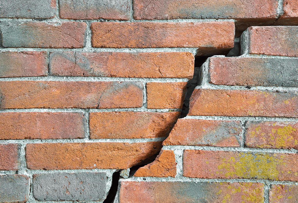 photo: red brick wall with large crack running through it (iStockphoto)